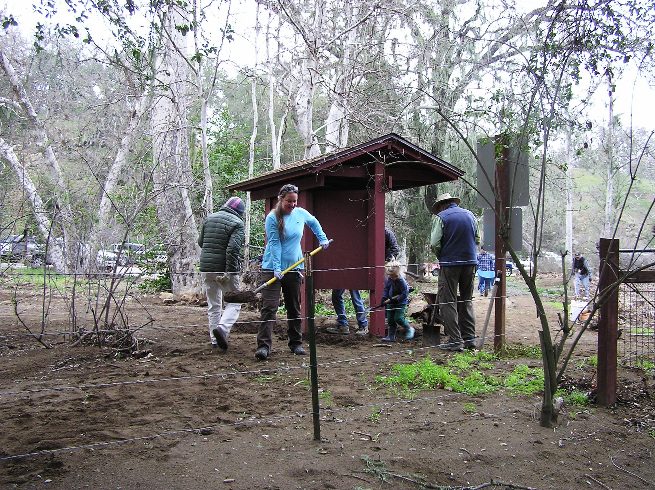 Removing the 8 inches of silt from around the kiosk.